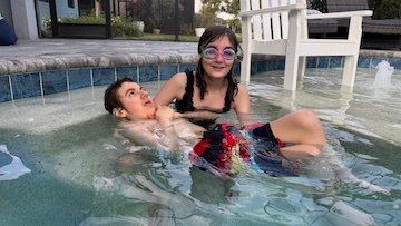Olivia holding Charlie in a pool