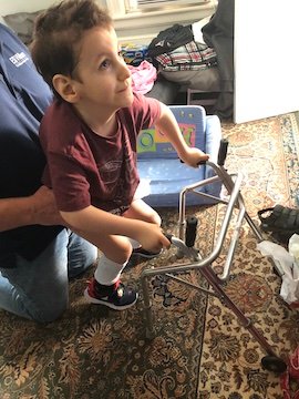 Charlie walking with a walker before his double hip surgery