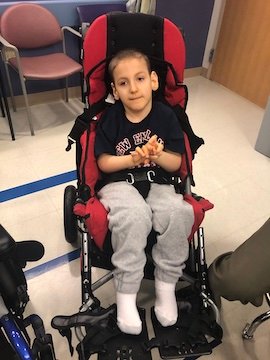 Charlie Karrat sitting in his stroller waiting for an appointment at a doctor's office.