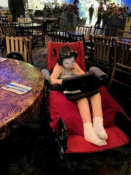 Charlie watching his ipad at Rainforest Cafe.